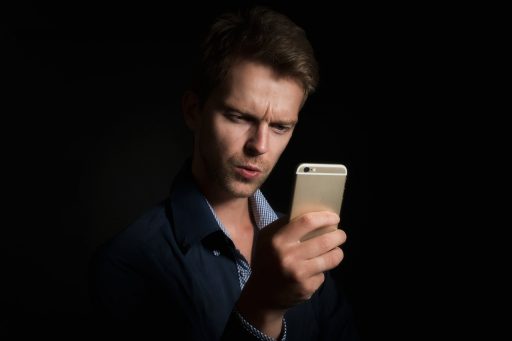 Persoon die ontspannen op een bank een mentale gezondheid app gebruikt op zijn smartphone